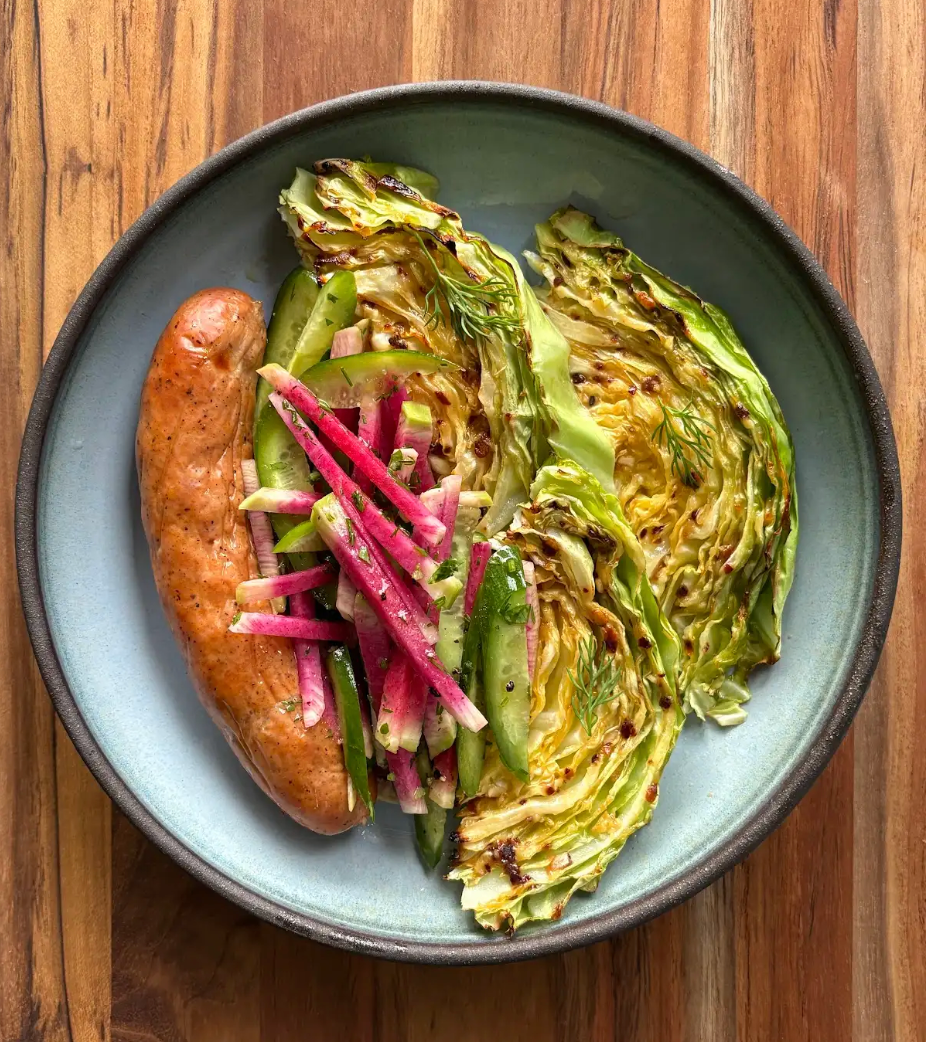 The Lottie Sausage with a plate of cabbage